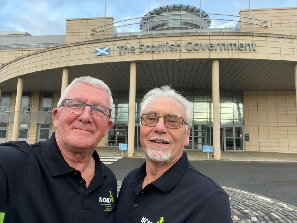Photo of Alan Tamblyn (General Secretary) and Dave Crisp (Communications Officer) outside The Scottish Government Building